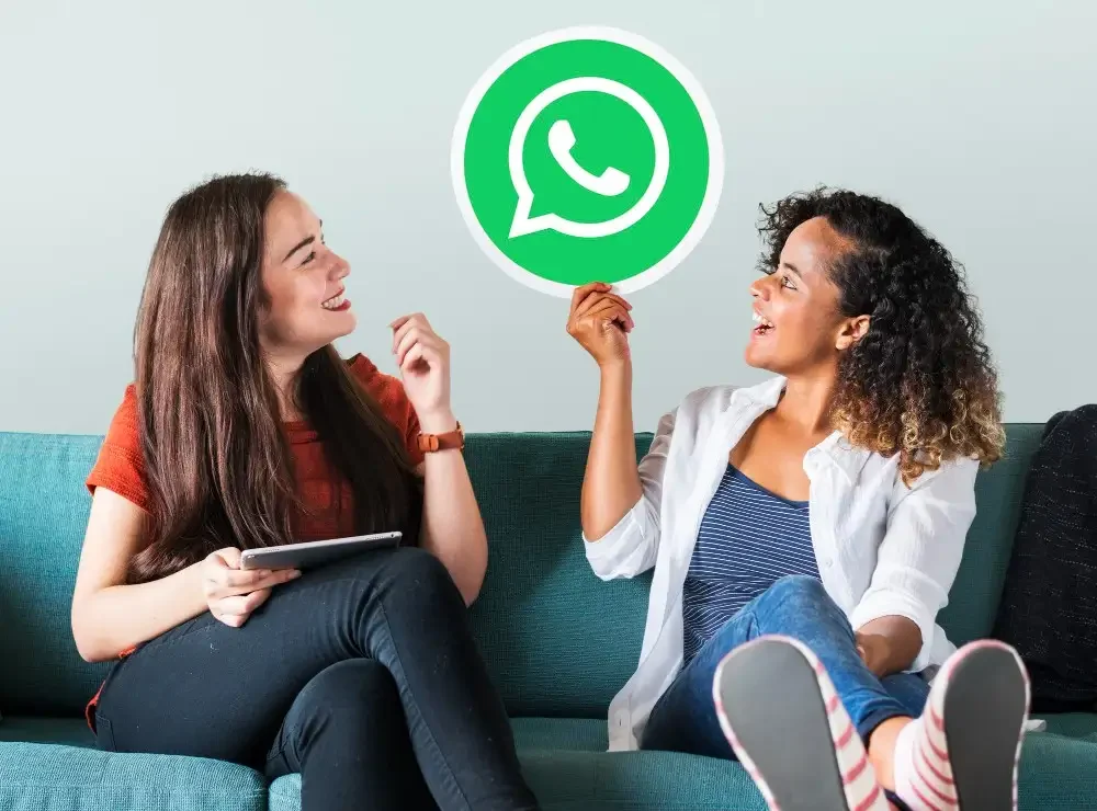 Young women showing whatsapp icon